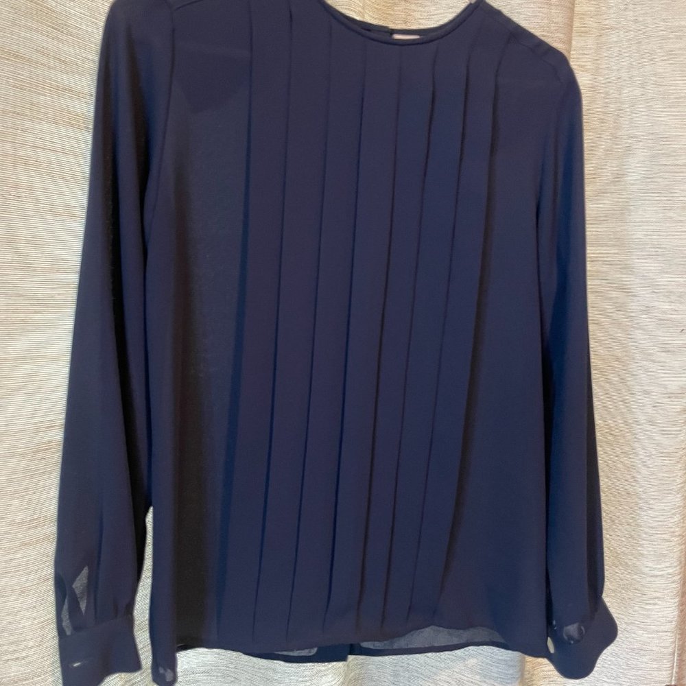 This is a sharp, silky, navy-blue top perfect piece to make you feel beautiful.